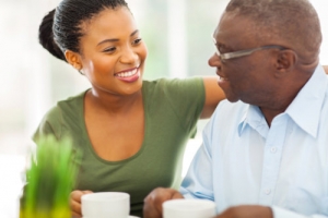 elderly man enjoying coffee with his caregiver