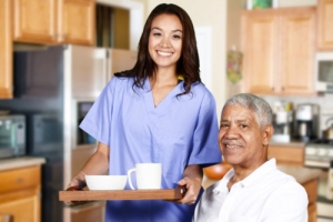 caregiver and elderly man smiling